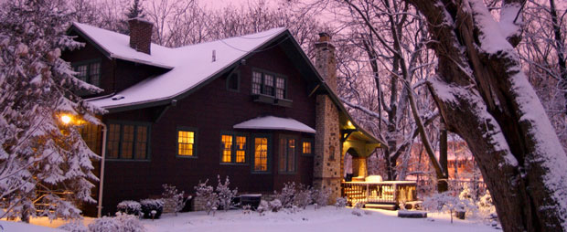 home in wintertime with snow at sunset