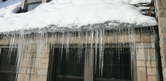 ice dam and icicles hanging from roof