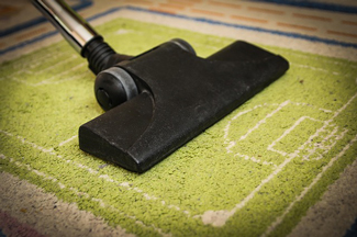 vacuum cleaning a green rug